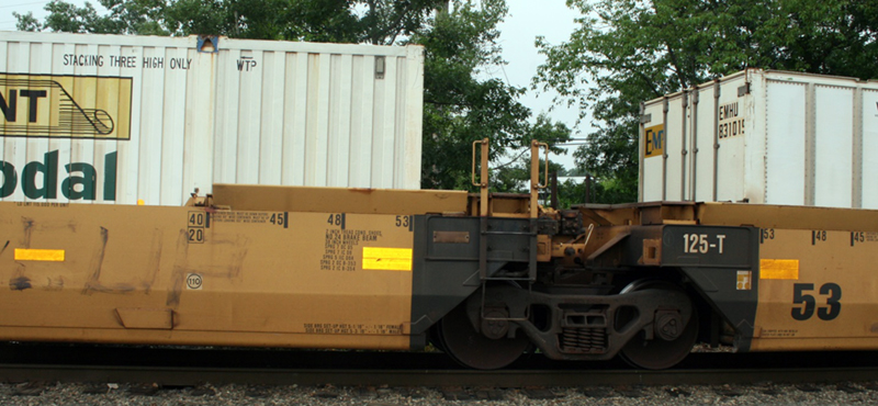 FIGURE 7. Well Car (also known as Double-Stack Car)
This image shows a low-floor well car carrying a full-sized container.
